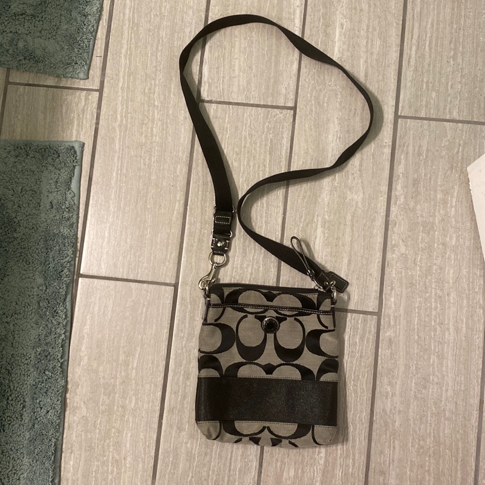 Small black and grey logo Coach purse.